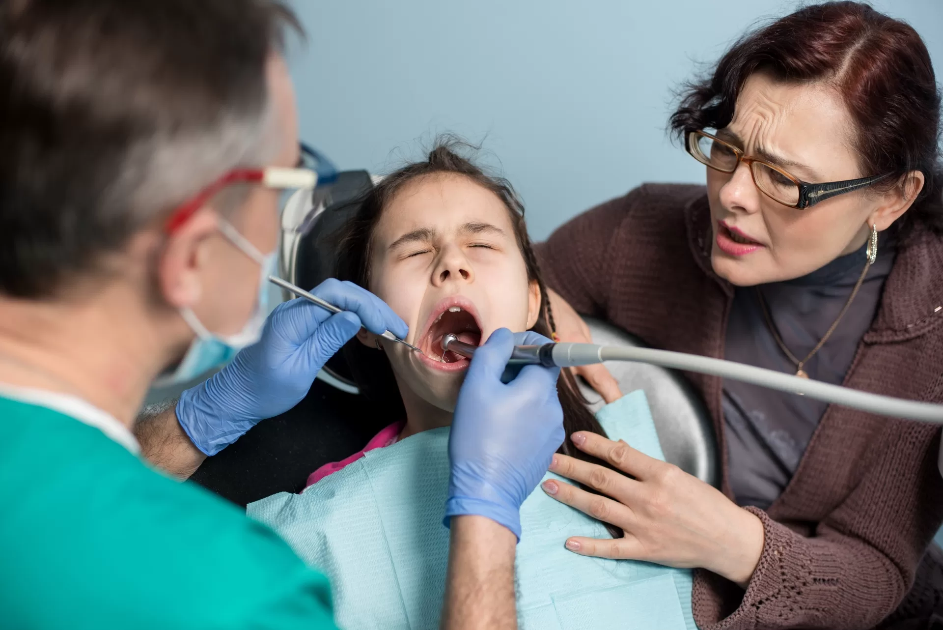 A pediatric dental examine in New Jersey to assess early signs of impacted canines with parent supervision.