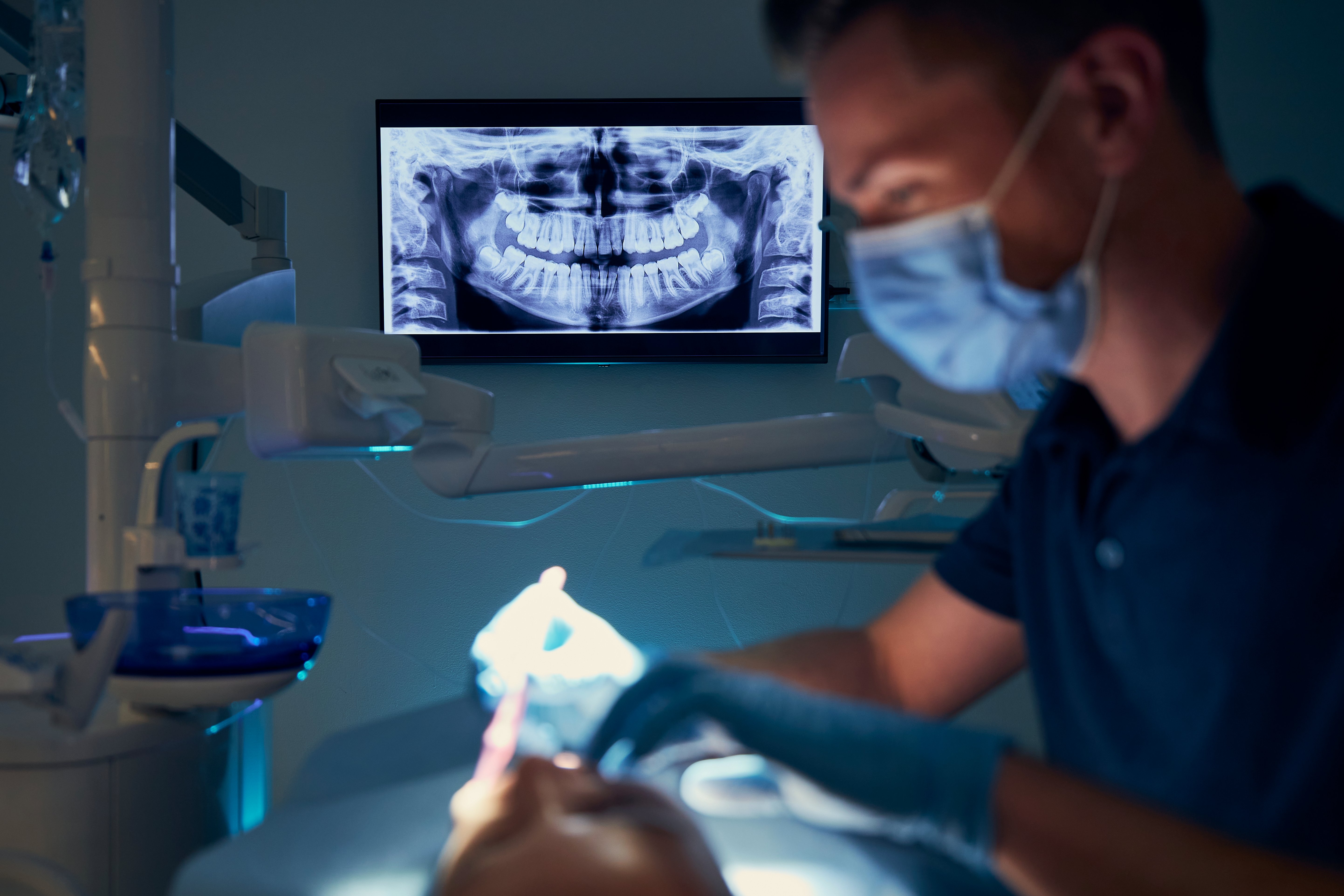 3D illustration showing a dental implant placed into the jawbone with bone graft material supporting the surrounding bone structure.