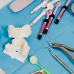 Dental equipment tools include instruments like probes, scalers, mirrors, and drills, used for exams, cleanings, and procedures.