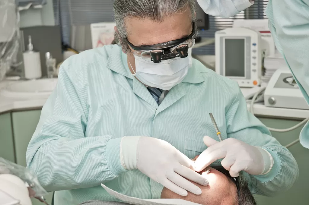 A dentist performing an operation on a patient in a modern dental clinic with professional equipment.