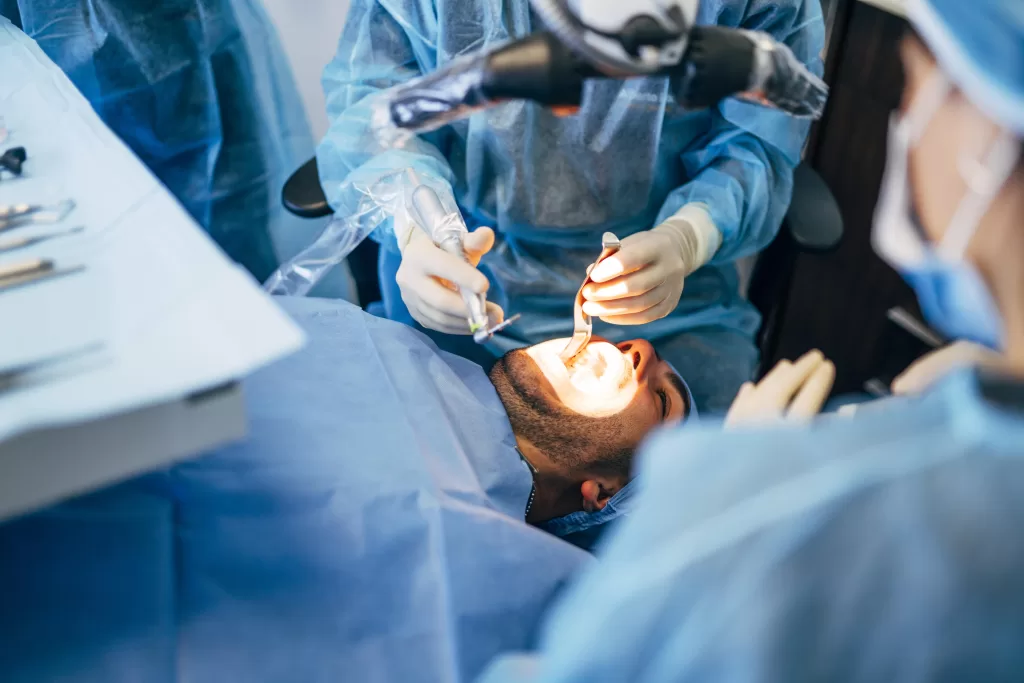 Oral surgeons performing a specialized dental procedure in a surgical setting at Morristown’s premier oral surgery facility.