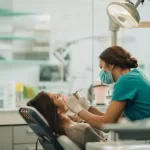 Patient receiving dental care from a professional dentist in a clinic.