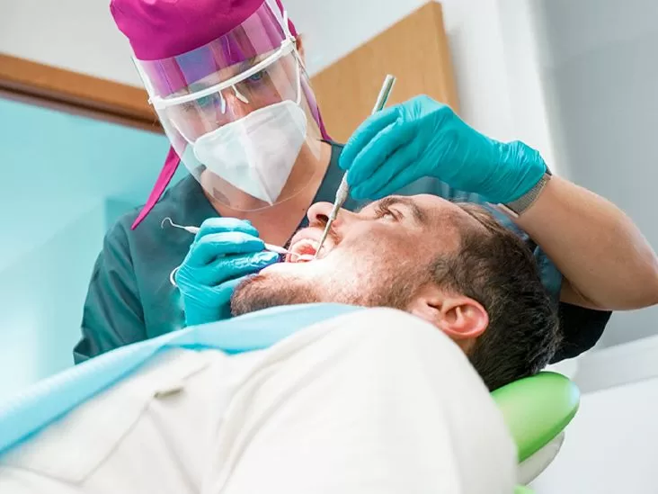 A dentist performing a procedure related to a dental implant with bone loss.