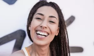 A smiling woman showing healthy gums and promoting awareness about gum disease prevention.