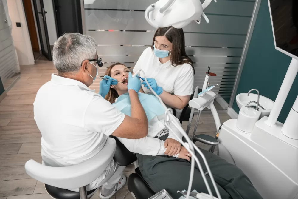 Doctors operating on a patient and performing an oral surgery