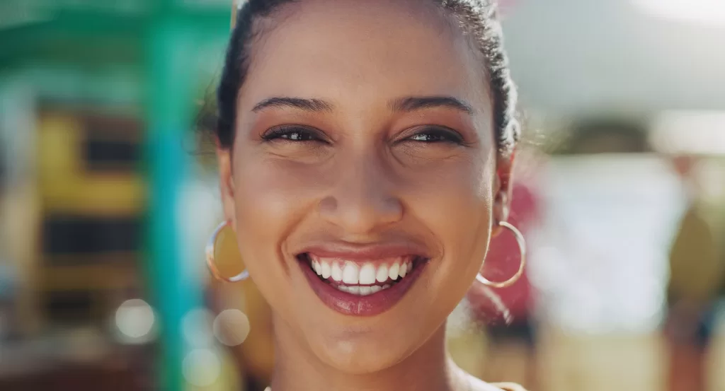 A close-up of a smiling person with bright, healthy teeth, symbolizing the positive results of a successful oral surgery procedure.