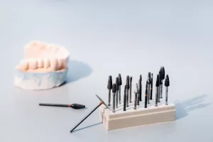 Dental tools, including burs and a dental model, used in the placement of Zirconia Implants.