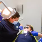 Child receiving professional oral care at the dentist with a thorough dental examination.