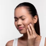 Close up of a woman suffering from wisdom tooth pain