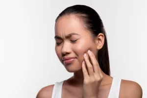 Close up of a woman suffering from wisdom tooth pain