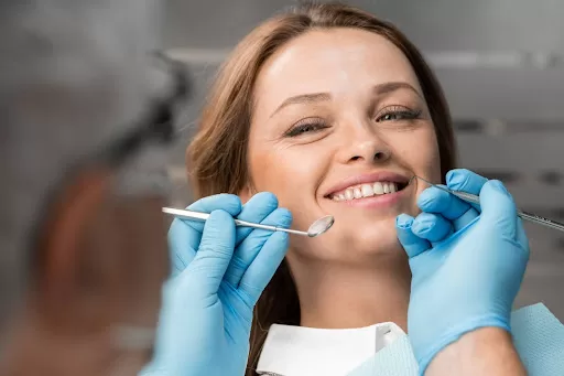 Dental surgeon performing “smile in a day” procedure on a patient