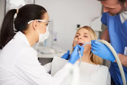 Two dentists examining a patient’s dental well-being.