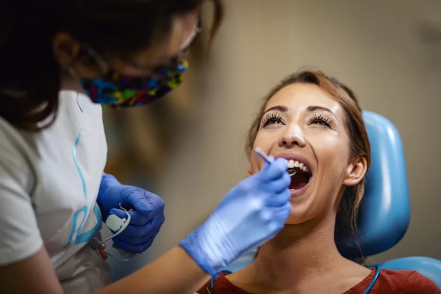 Dentist examining patient’s teeth at Ridge Oral Surgery in New Jersey for potential wisdom teeth issues.