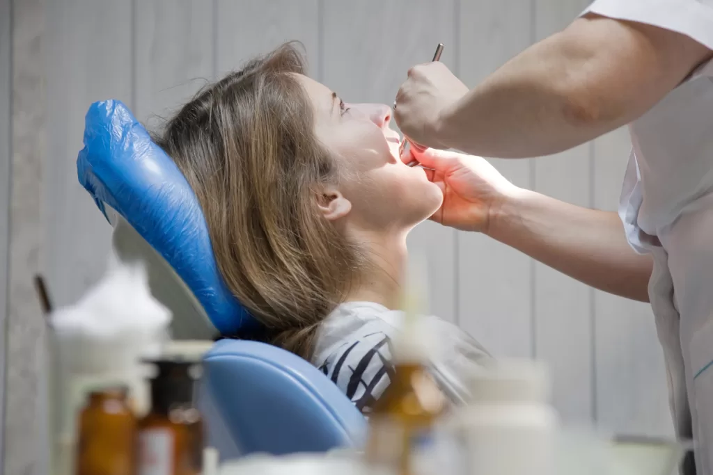 Patient undergoing a dental checkup to detect jaw cysts or oral tumors.