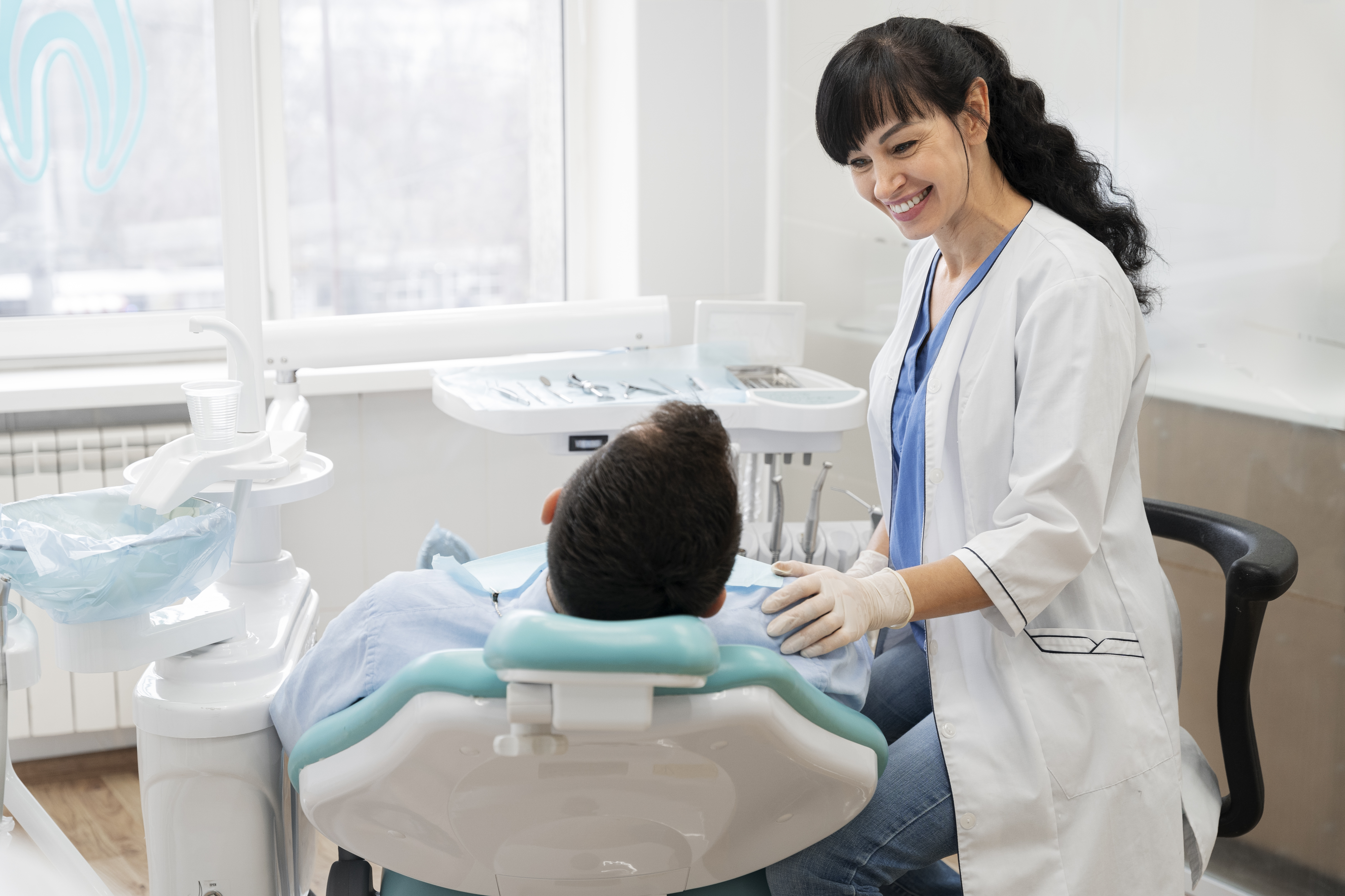 Friendly dentist in a Ridge Oral Surgery clinic conducting a routine check-up on a relaxed patient.