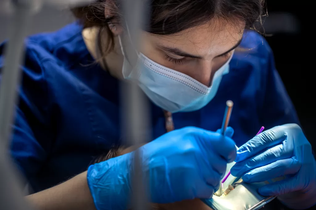 Dentist carefully treating a young patient’s tooth to maintain jawbone health at Ridge Oral Surgery in New Jersey.