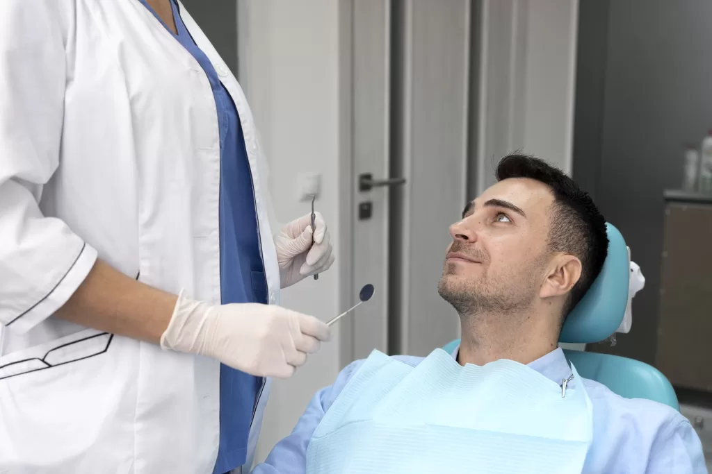 Dentist performing a detailed examination of a patient at the Ridge Oral Surgery clinic, checking for signs of bone resorption and health issues.