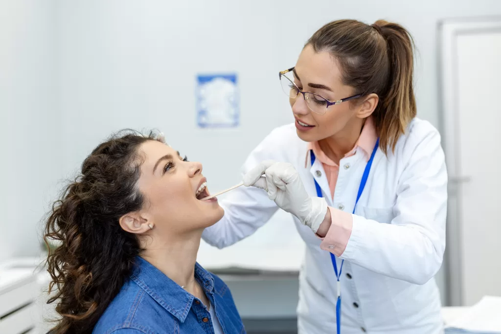 A dentist assessing a woman’s mouth to evaluate gum and bone health related to hormonal changes.