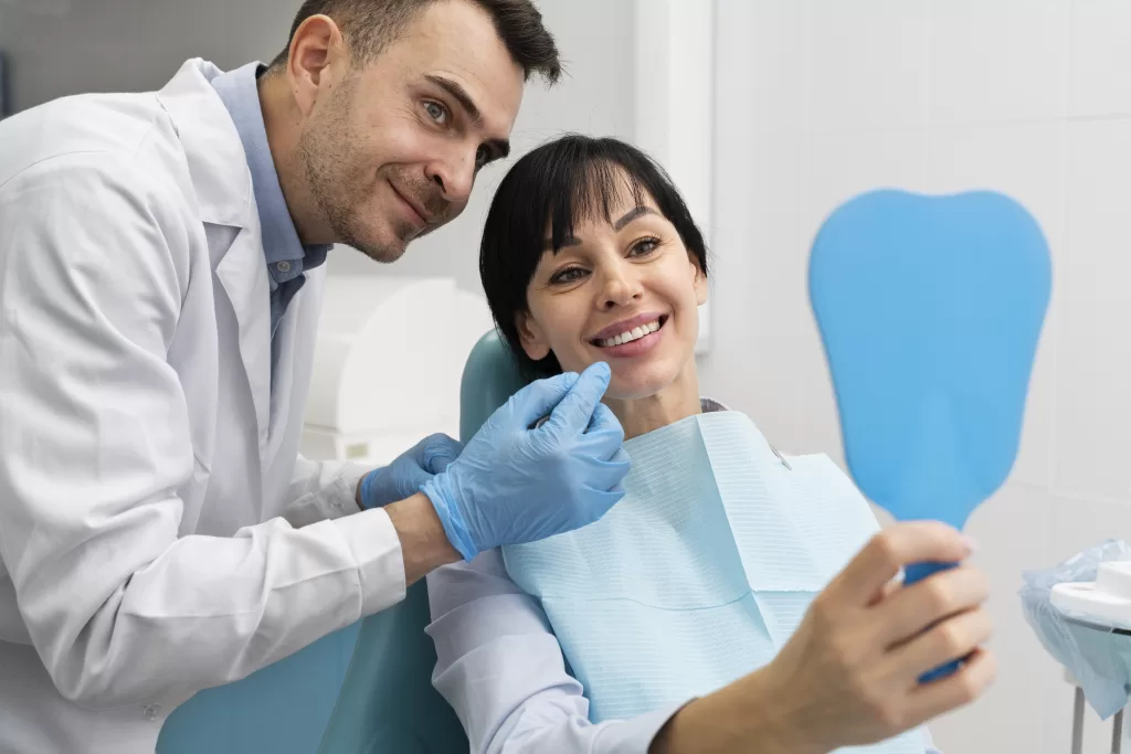 A smiling patient reviewing her dental implant results with an oral surgeon at Ridge Oral Surgery clinic.