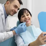 A smiling patient reviewing her dental implant results with an oral surgeon at Ridge Oral Surgery clinic.