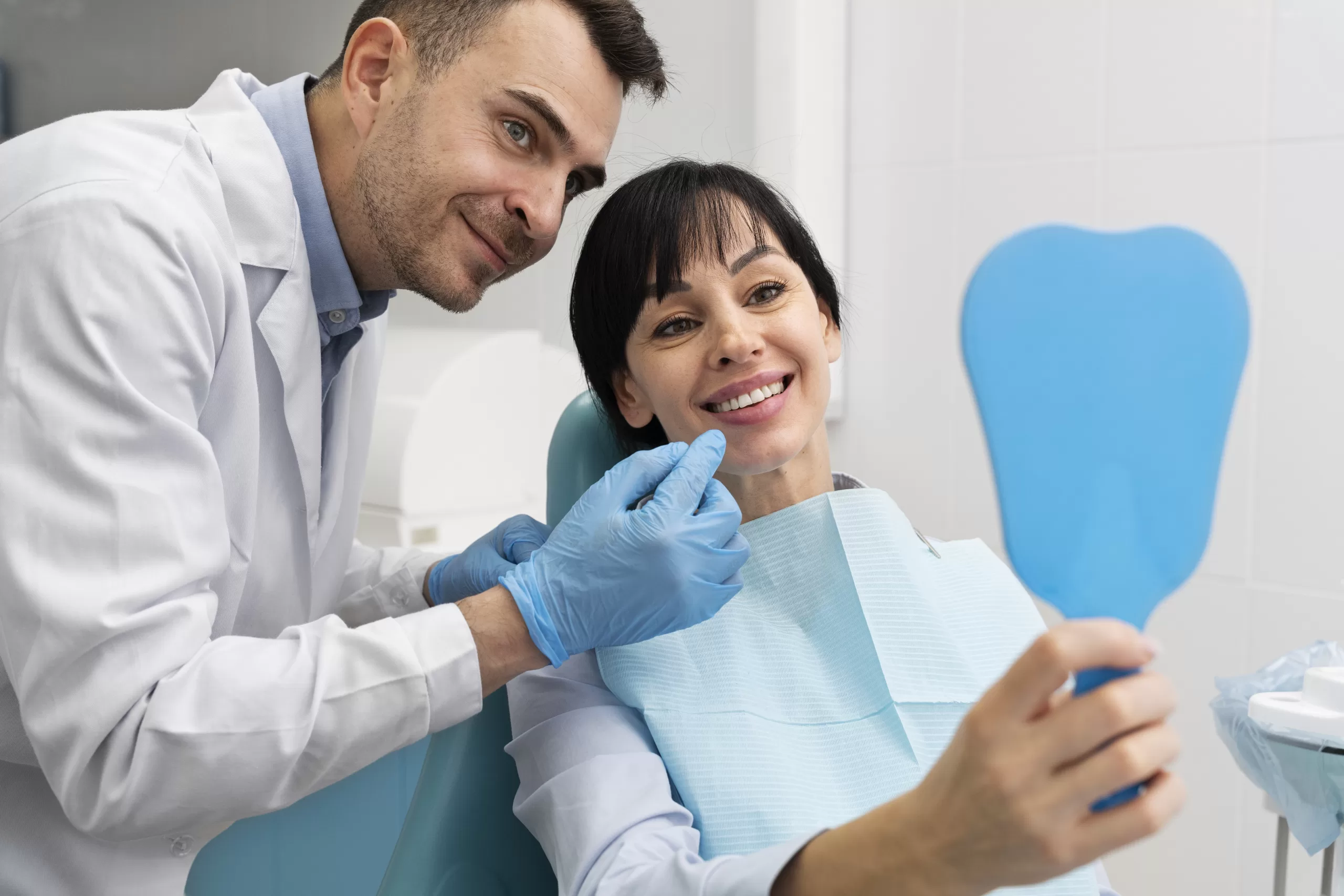 A smiling patient reviewing her dental implant results with an oral surgeon at Ridge Oral Surgery clinic.