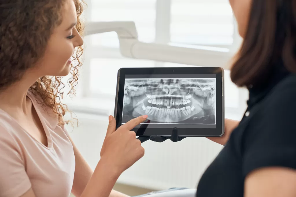 Close-up of a dental CBCT scan displayed on a tablet at Ridge Oral Surgery clinic.