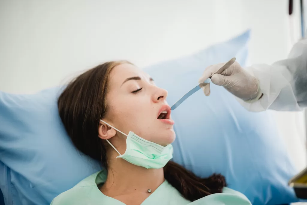 A dental professional performing a check-up on a patient at the Ridge Oral Surgery clinic.