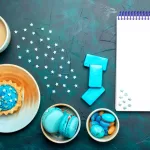 Flat lay of a planner, coffee, and holiday treats symbolizing a post-holiday dental health check and a fresh start for oral care.