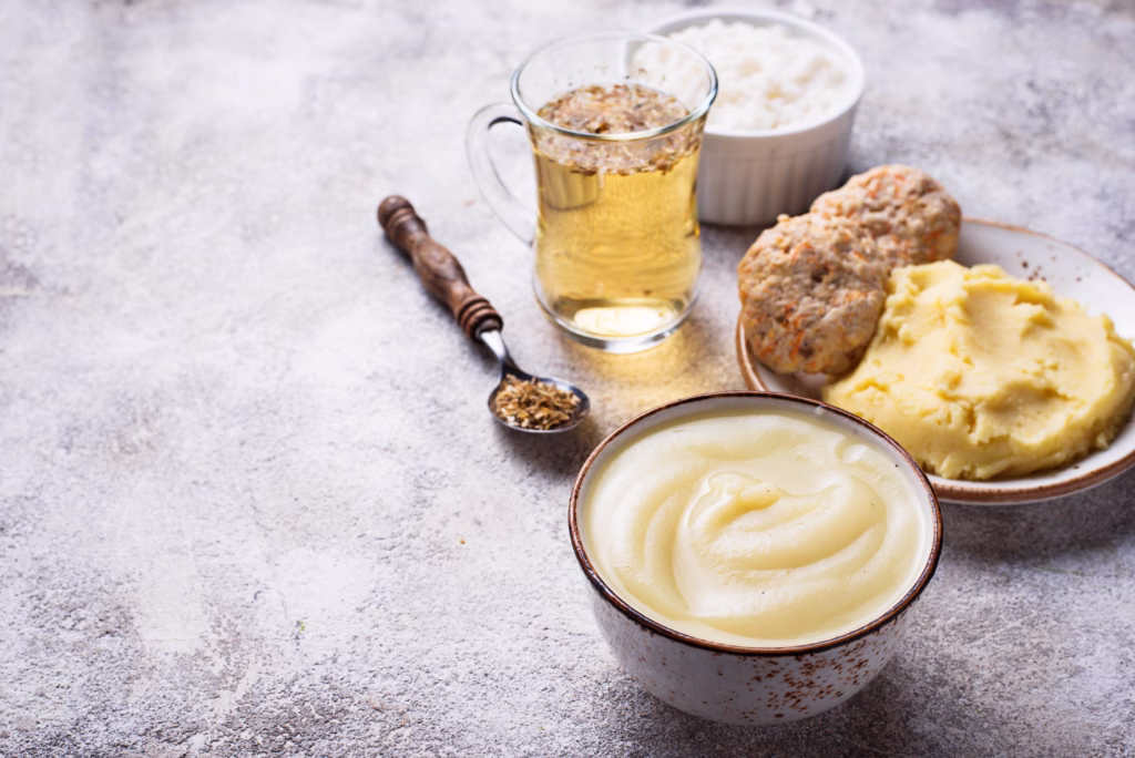 Selection of soft recovery foods including mashed potatoes, purees, and other easy-to-eat options prepared for patients recovering from wisdom teeth removal surgery.