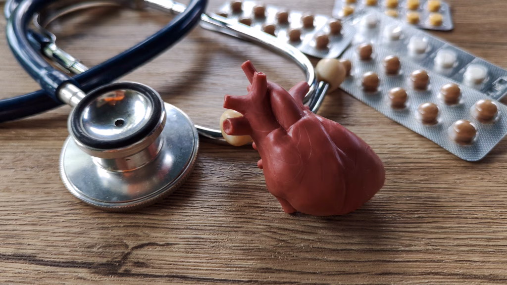 Medical stethoscope, heart model, and medication illustrating patient safety.