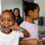 Children brushing their teeth together as part of a daily oral hygiene routine.