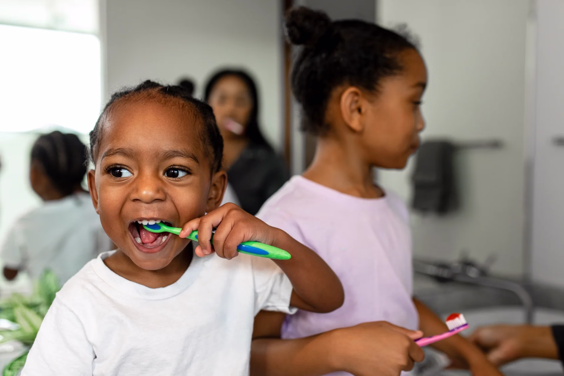 Children brushing their teeth together as part of a daily oral hygiene routine.